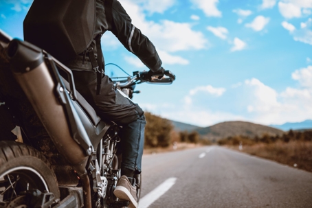 man riding a motorcycle on an open road